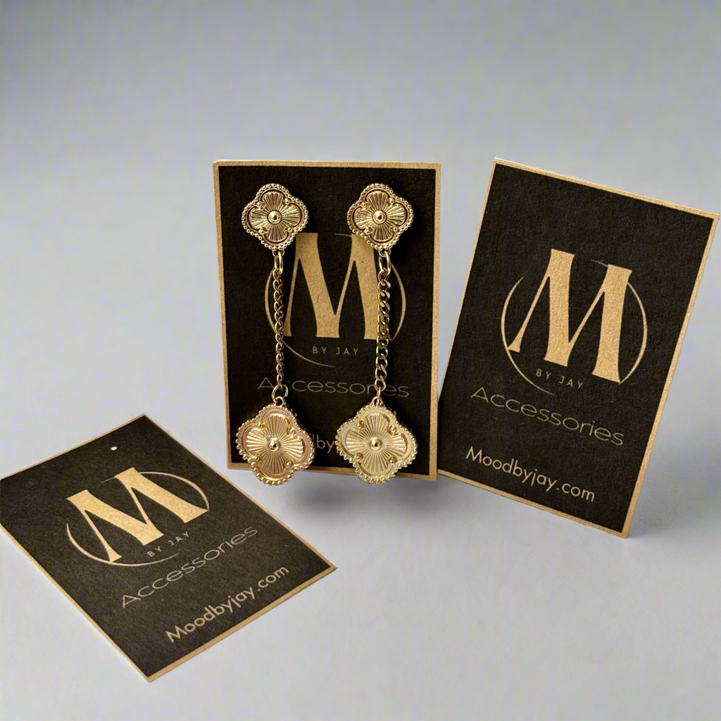 Close up front view of elegant 18K gold plated designer-inspired Van Cleef dangle drop chain earrings. Lightweight and versatile design, with long lasting, waterproof plating perfect for any occasion, from casual outings to formal events.
