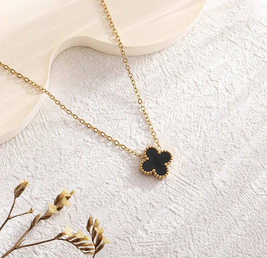Close up front view of elegant 18K gold plated black designer-inspired Van Cleef clover necklace dupe. Lightweight and versatile design, with long lasting, tarnish resistant, waterproof plating perfect for any occasion, from casual outings to formal events. 
  