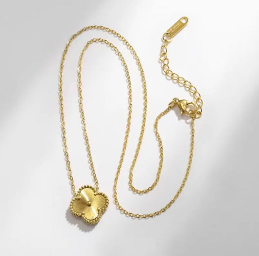Close up front view of elegant 18K gold plated designer-inspired Van Cleef clover necklace. Lightweight and versatile design, with long lasting, waterproof plating perfect for any occasion, from casual outings to formal events. 
  