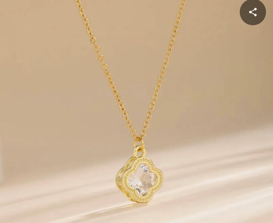 Close up front view of elegant 18K gold plated designer-inspired Van Cleef crystal clover necklace.  Lightweight and versatile design, with long lasting, waterproof plating perfect for any occasion, from casual outings to formal events. 