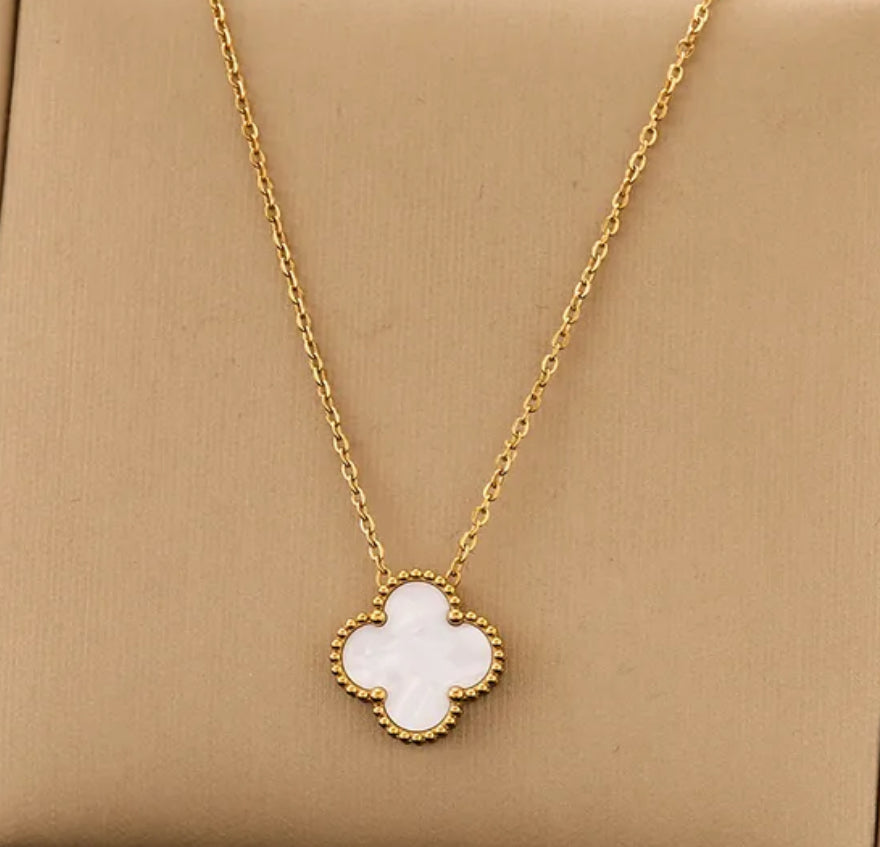 Close up front view of elegant 18K gold plated pearl white designer-inspired Van Cleef clover necklace. Lightweight and versatile design, with long lasting, waterproof plating perfect for any occasion, from casual outings to formal events. 