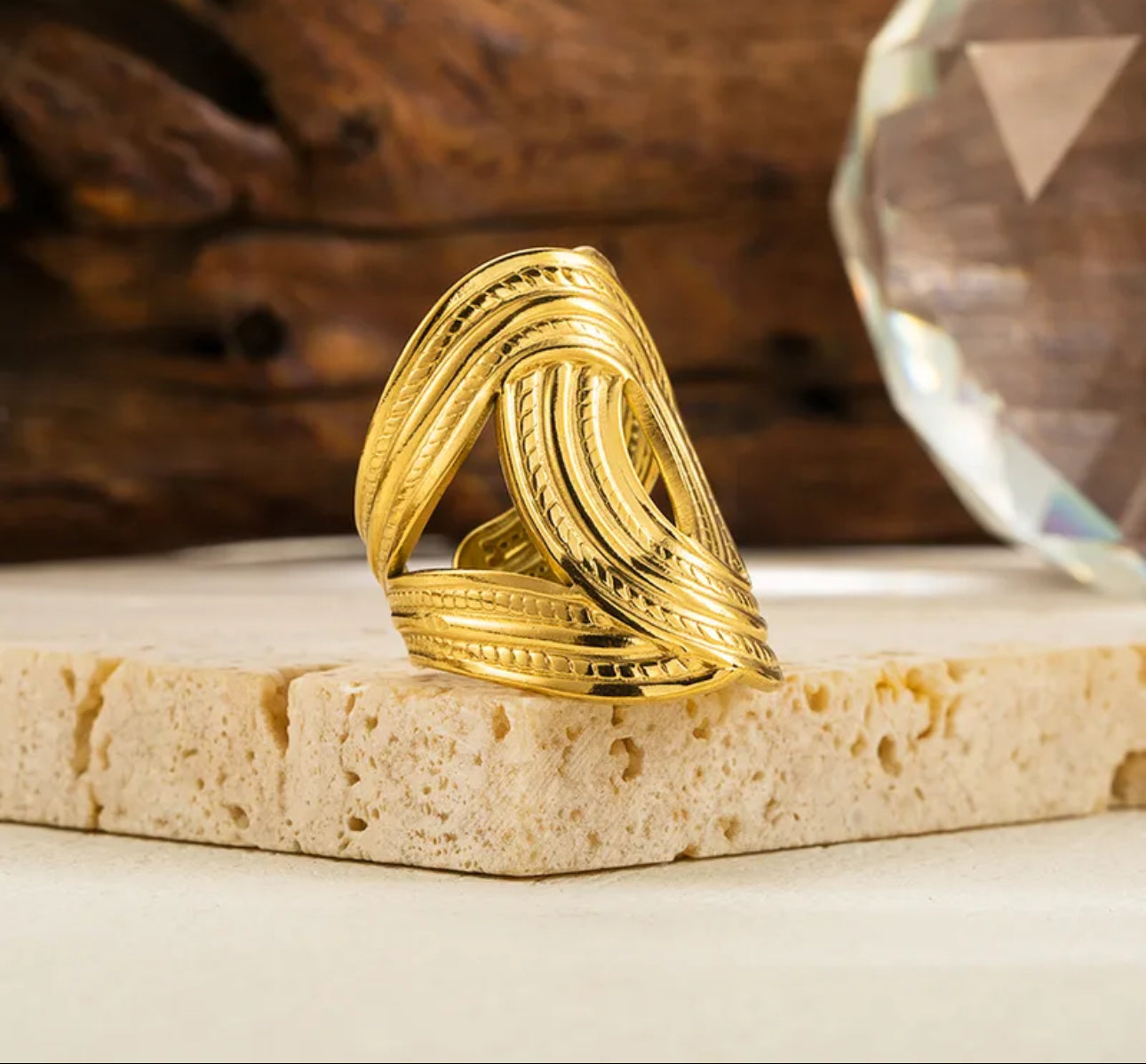 Close up view of elegant and durable 18k gold-plated 304 stainless steel, adjustable statement ring with a smooth polished finish, designed with a lightweight and tarnish resistant material for long wearing timeless sophistication.