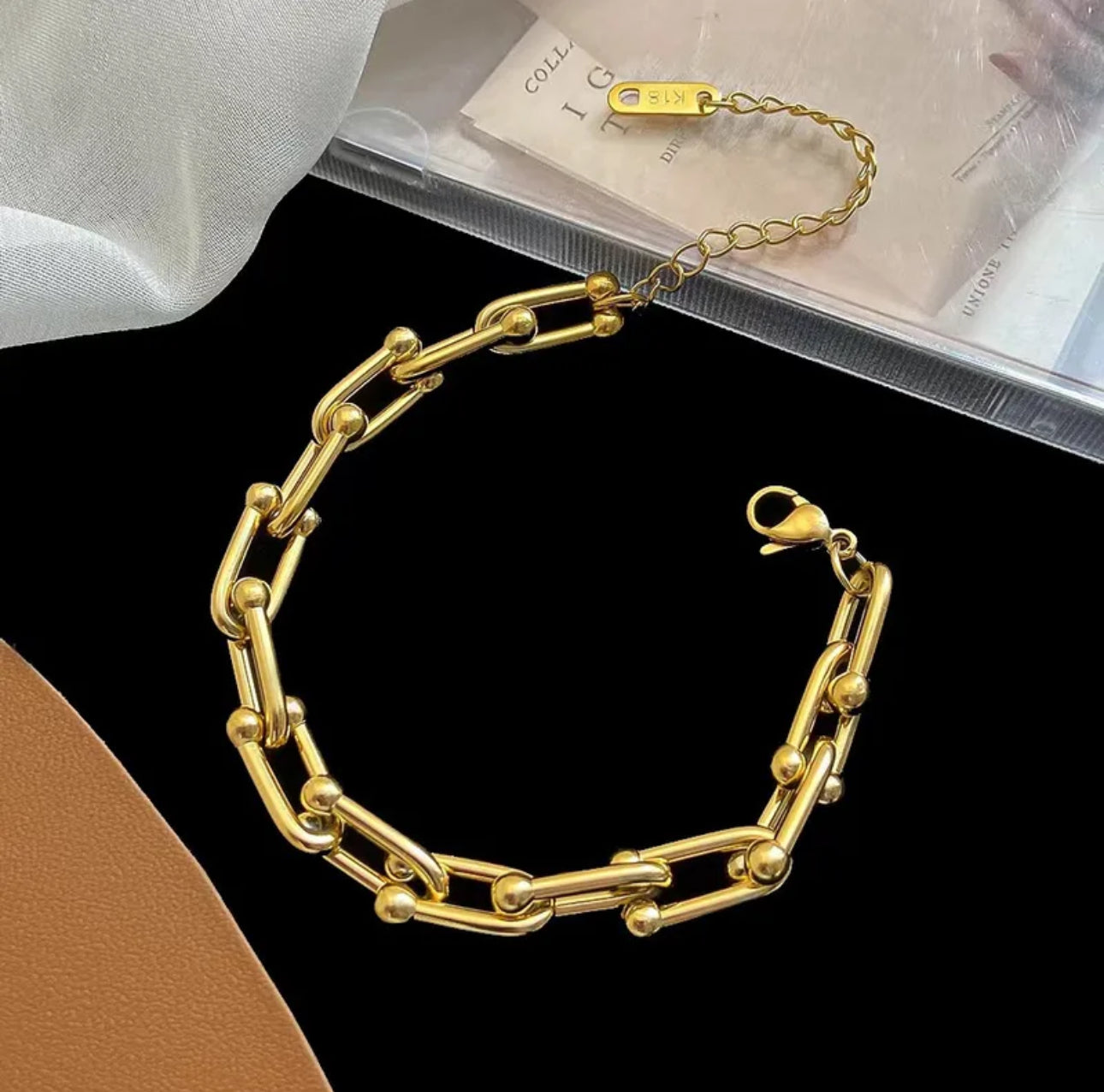 Close up view of elegant 18k Gold plated stainless steel designer inspired, Tiffany link chain bracelet dupe with a smooth, polished finish, designed with a lightweight and tarnish resistant material for timeless sophistication.