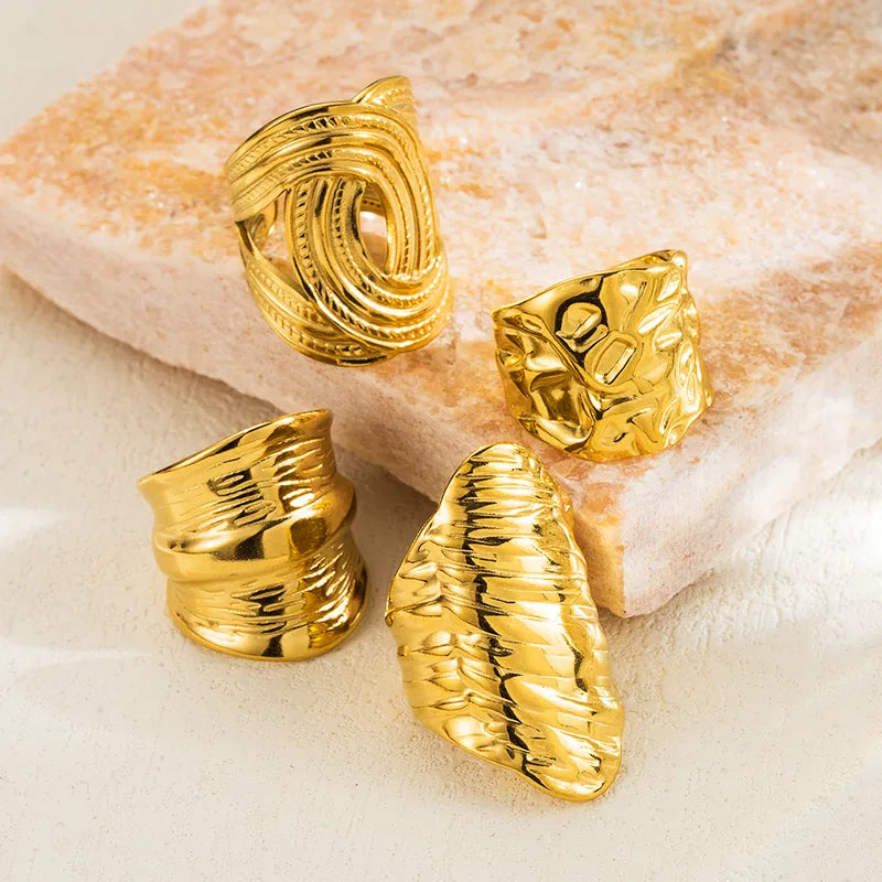 Close up view of 4 elegant and durable 18k gold-plated 304 stainless steel, adjustable statement ring with a smooth polished finish, designed with a lightweight and tarnish resistant material for long wearing timeless sophistication.