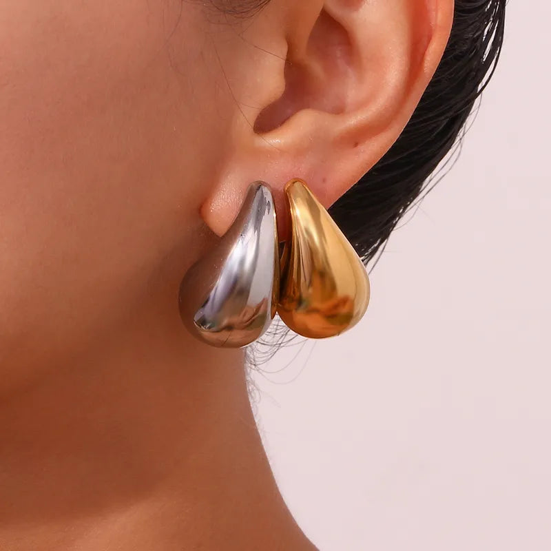 Close up front model view of elegant 18k Gold and Silver plated stainless steel, Bottega designer-inspired teardrop earrings with a smooth, polished waterproof finish, designed with a lightweight and tarnish resistant material for timeless sophistication.