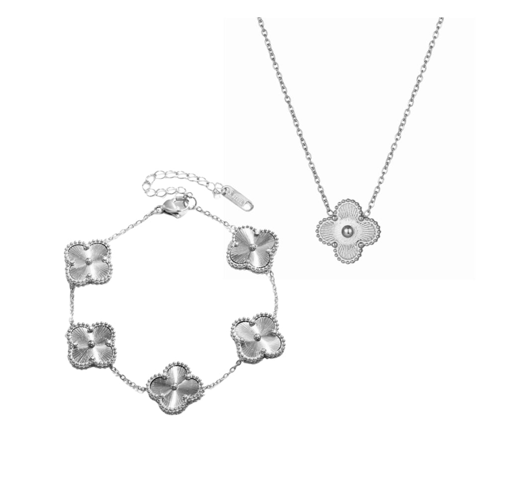 Close up front view of elegant 18K silver plated designer-inspired Van Cleef clover necklace and bracelet set.  Lightweight and versatile design, with long lasting, waterproof plating perfect for any occasion, from casual outings to formal events. 