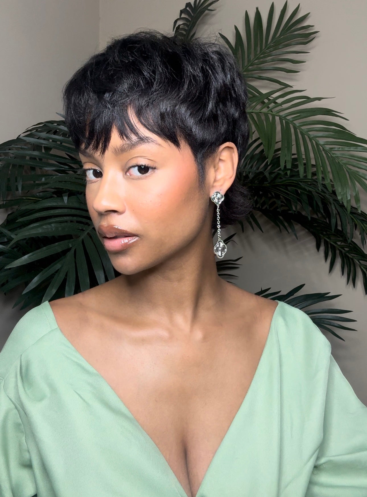 Close up front view of elegant 18K gold plated designer-inspired Van Cleef dangle drop chain earrings.  Lightweight and versatile design, with long lasting, waterproof plating perfect for any occasion, from casual outings to formal events. 