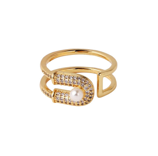  A stunning pave diamond encrusted adjustable gold plated stainless steel ring, with an elegant pearl center. Flirty and sophisticated, this adjustable ring is perfect for adding a hint of glamour to any outfit.
